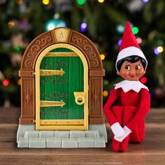 an elf is standing next to a green door