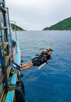 a person is diving in the ocean from a boat