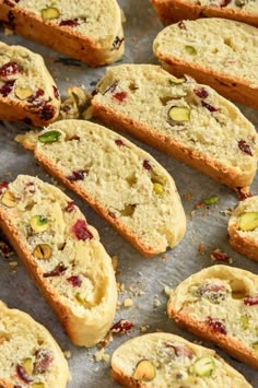 several pieces of bread with nuts and cranberry toppings