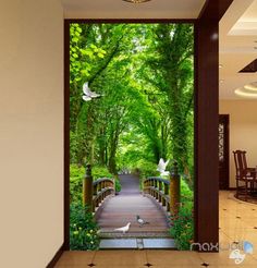 an open door leading to a walkway in the middle of a forest with birds flying over it