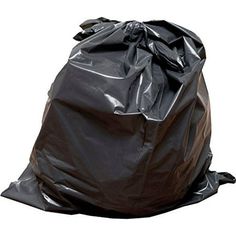 a large black bag sitting on top of a white floor next to a trash can