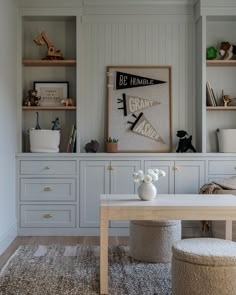 a living room with white furniture and shelves