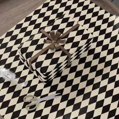 a black and white checkered table with a present on it