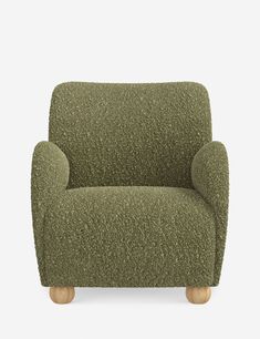 a green chair sitting on top of a white floor