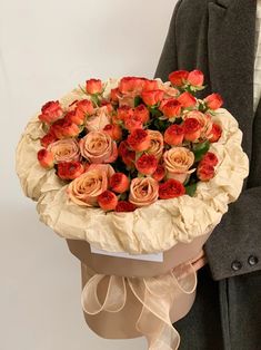 a man holding a bouquet of roses in his hands