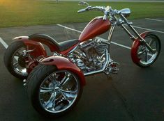 a red motorcycle parked in a parking lot