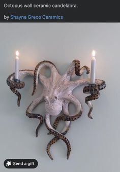 an octopus wall candle holder with two candles