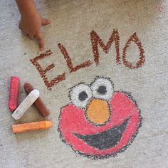 a child's hand is drawn on the ground with chalk and crayons