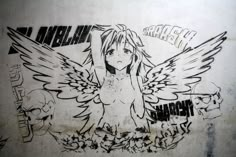 a drawing of a girl with wings and skulls on the wall