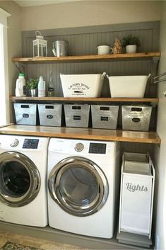 a washer and dryer in a laundry room with shelves above them that hold baskets