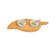 two bowls with chopsticks sitting on a bamboo serving tray that is shaped like a leaf