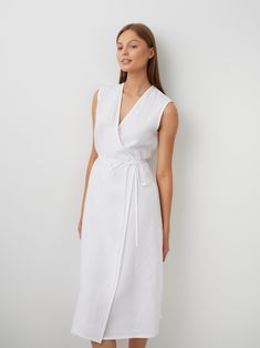 "PIA is an elegant sleeveless wrap linen midi dress.  DETAILS - True wrap - Sleeveless - Midi length - Oeko-Tex certified 100% local washed midweight linen - Cut and sewn to order just for you in our studio COLOR - White, you can also choose other colors above - Fabric samples are available here https://www.etsy.com/listing/586569696/linen-fabric-samples SIZING & FIT - Fit true to size - Model is 5'10\" / 178cm and wearing a size S CARE FOR LINEN - Machine wash up to 30ºC/86ºF gentle cycle - Lay flat to dry or tumble dry low - Warm iron if needed - Do not bleach SIZE GUIDE Size conversion guide Size XS (US 0-2, IT 36-38, UK 4-6, Japan 3-5, France 32-34) Size S (US 4-6, IT 40-42, UK 8-10, Japan 7-9, France 36-38) Size M (US 8-10, IT 44-46, UK 12-14, Japan 11-13, France 40-42) Size L (US 12- Elegant Sleeveless Linen Dress, Elegant Summer Linen Wrap Dress, Beach Linen Wrap Dress, Midi Length, Elegant Wrap Linen Beach Dress, Elegant Linen Wrap Maxi Dress, Elegant Sleeveless Linen Dress For Daywear, Sleeveless Linen Dress With Tie Waist, Linen Wrap Skirt, Linen Wrap Dress