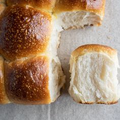 a loaf of bread cut in half on top of a piece of paper