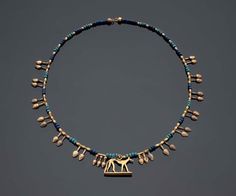 Lovely New Kingdom necklace.  Twenty-four electrum nefer pendants; two triple nefer pendants; fifty-one barrel beads. Strung with grouped ball beads of dark and light blue glass. Center: gold jackal amulet. New Kingdom, Dynasty 18 1550–1295 B.C. Between 1900 and 1907, acquired in Egypt by Goddard Du Bois (b. 1869 – d. 1925) and Josephine Cook Du Bois (b. 1864 – d. 1961), New York; 1945, gift of Mrs. Du Bois to the MFA. (Accession Date: December 27, 1945) Egypt Jewelry, Ancient Egyptian Jewelry, Ancient Jewellery, Historical Jewellery, Long Pearl Necklaces, Ancient Egyptian Art, Egyptian Jewelry, Pearl Jewelry Necklace, Ancient Jewelry