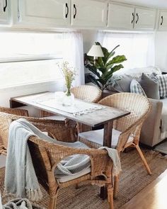 a living room with wicker furniture and white walls