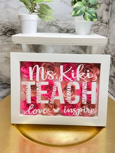 a white frame with pink flowers and the words make teah love inspire on it