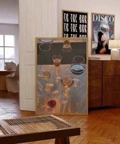 a room with wooden floors and pictures on the wall, including wine glasses in front of them