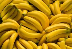 several bunches of bananas are piled up in the same pattern as they appear to be ripe