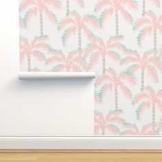 a wall with pink and green palm trees on it