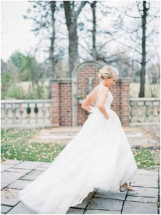 a woman in a white dress is walking