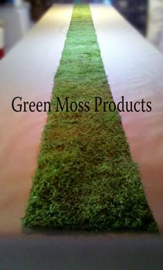 green moss products are lined up on a long table with the words green moss products written across it