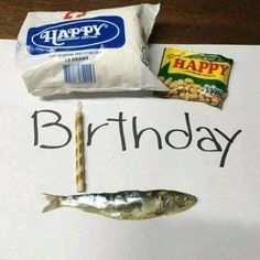 a happy birthday card with fish, chips and candy on the table next to it