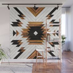 an artistic wall mural in a living room with wood flooring and white walls, along with a wooden ladder