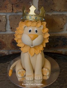 a cake with a lion wearing a crown on top of it's head and legs