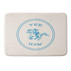 a blue and white bath mat with the words yee haw printed on it