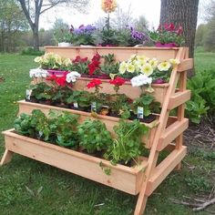 a wooden planter filled with lots of flowers