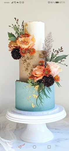 a three tiered cake with flowers on top