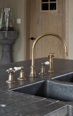 two faucets are on the kitchen counter top