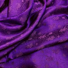 an image of purple fabric with floral design on the top and bottom half of it