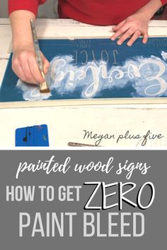 a woman is painting wood signs with white paint on the top and bottom part of it