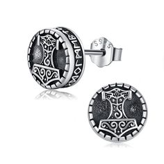 two pairs of silver earrings with black and white designs