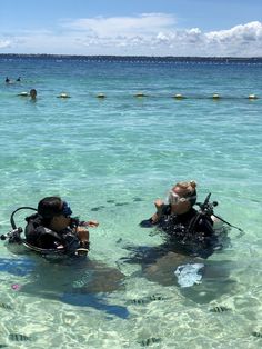 two people in the water with scuba gear