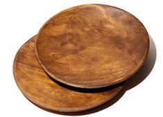 two wooden plates sitting on top of each other