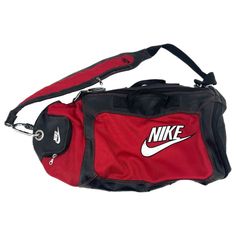 This Nike Duffel Bag In Striking Red And Black Is Not Just A Bag, It's A Way Of Life! Perfect For The Gym, A Weekend Getaway, Or Simply Strutting Your Stuff Around Town, This Bag Is As Versatile As You Are. Crafted From Durable Nylon And Polyurethane, It Exudes A Classic Style That Can Keep Up With Your On-The-Go Lifestyle. With A Large Size And A Zip Closure, Your Belongings Are Sure To Stay Secure. Plus, Its Adjustable Strap And Multiple Pockets Ensure That You Stay Organized And Comfortable Wherever You Go. Features: - Made In China - Adjustable Strap - Inner And Outer Pockets - Anti-Theft Feature - Suitable For All Seasons - Measurements: Bag Height: 13 In, Bag Width: 24 In, Bag Depth: Nike Duffel Bag, Black Duffel Bag, Nike Red, A Way Of Life, Anti Theft, Weekend Getaway, Stay Organized, Way Of Life, Duffel Bag