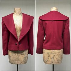 * Cropped wool jacket c 1980s* Cranberry wool fabric* Super wide shawl collar * Long, set-in sleeves* Padded shoulders* Antiqued engraved metal buttons on chain closure* Cranberry satin liningExcellent condition. There is a stain on the lining that does not show through. See last image.Label: Evan Picone, ILGWU, Woolmark 100% imported wool - Made in USA - 12Bust: 40Waist: 38Sleeve: 21Length: 20Garments are flat-measured. Please compare these measurements to another flat-measured garment that fit Vintage Fitted Outerwear With Shawl Collar, Fitted Vintage Outerwear With Shawl Collar, Crop Jacket Pattern, 80s Suit, Engraved Metal, How To Iron Clothes, Cropped Blazer, Jacket Pattern, Padded Jacket