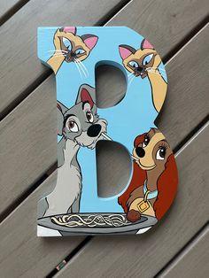 the letter b is made up of cartoon characters, including lady and the tramp