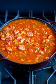 a pot filled with soup sitting on top of a stove