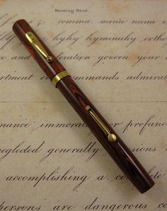 a pen sitting on top of an old manuscript