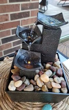 a water fountain with rocks and stones around it