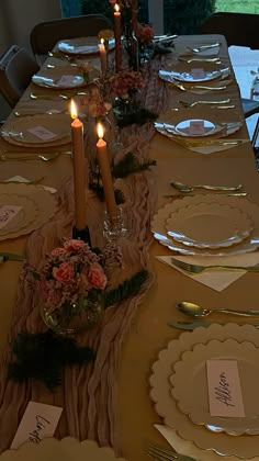 a table set with place settings and candles