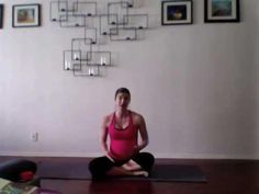 a woman is sitting on the floor in a yoga pose