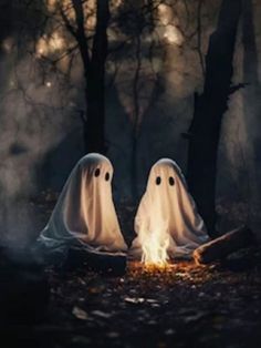 two ghost sitting in front of a campfire