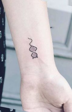 a black and white photo of a woman's arm with a spiral tattoo on it