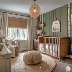 a baby's room with green and white striped walls, a crib, rocking chair, and large round rug