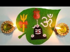 a green leaf decorated with an image of buddha and other decorations on it's side