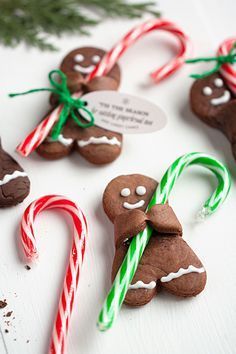 christmas cookies and candy canes on a white table